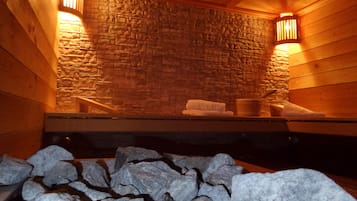 Relax in a serene sauna room with a bench and towel.