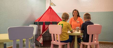 A room with a play tent, children's chairs, and a table.