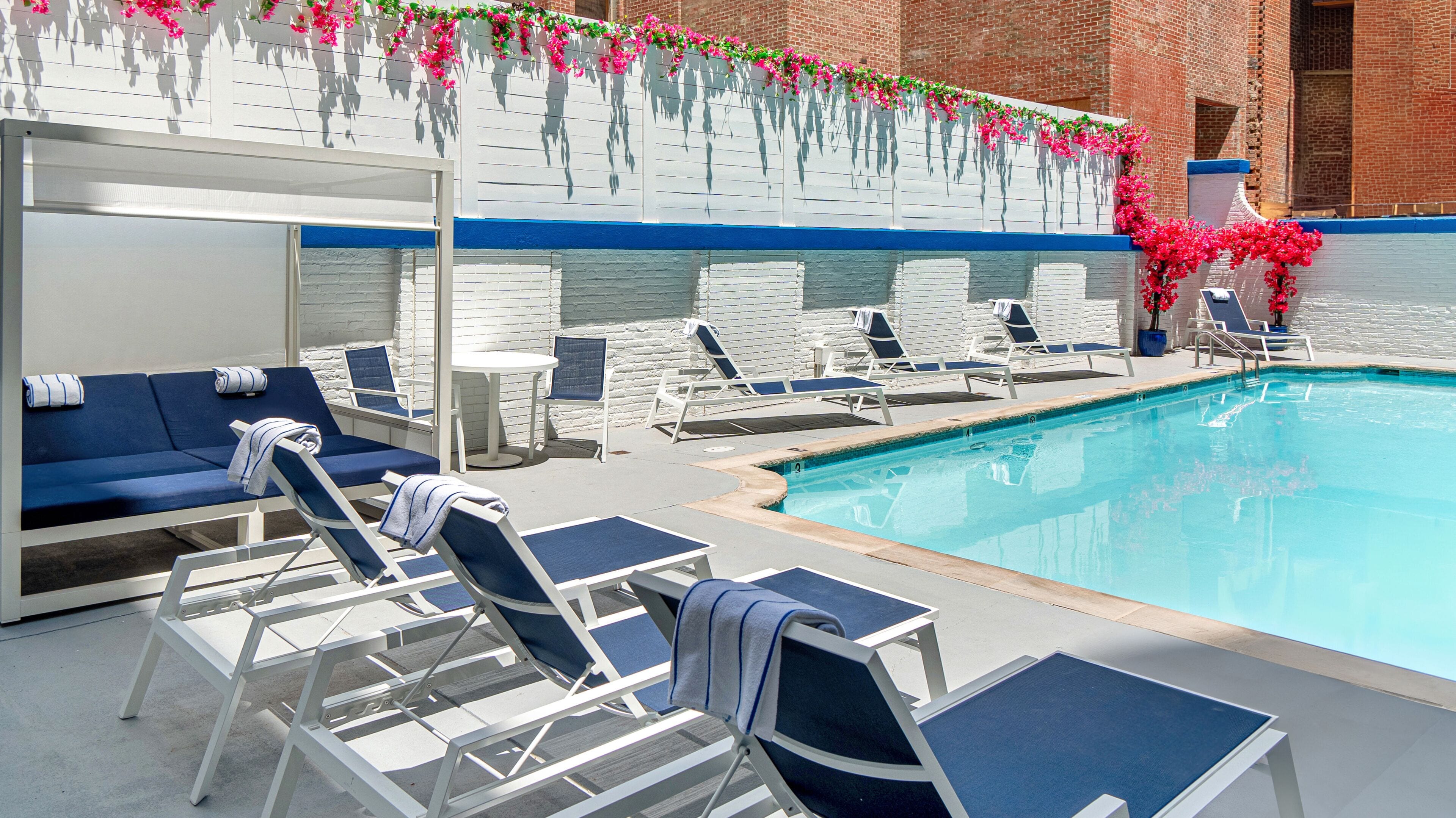 Seasonal outdoor pool, open 8:00 AM to 8:00 PM, pool umbrellas