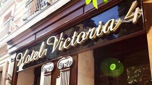 A hotel sign with the name "Hotel Victoria 4" and classical architectural details. - Hotel Victoria 4 (Madrid)