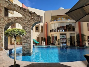 Outdoor pool, open 9 AM to 7 PM, pool umbrellas