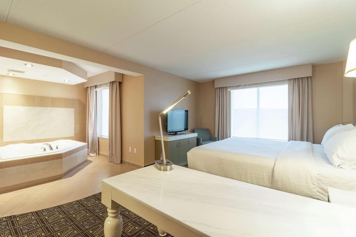 room, 1 king bed, jetted tub | premium bedding, desk, blackout curtains, iron/ironing board