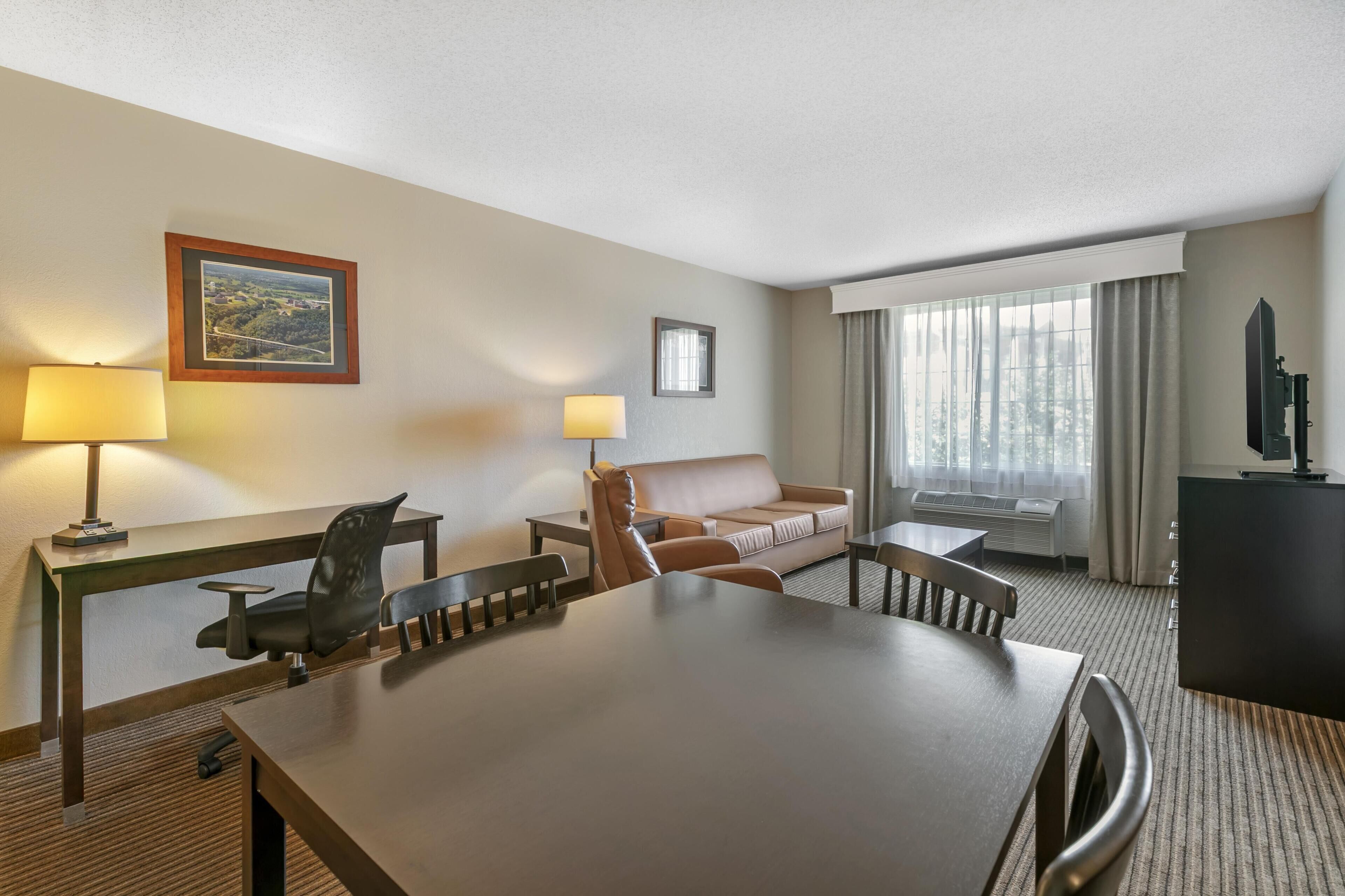 Hypo-allergenic bedding, desk, laptop workspace, blackout drapes