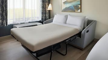 Premium bedding, desk, laptop workspace, blackout drapes
