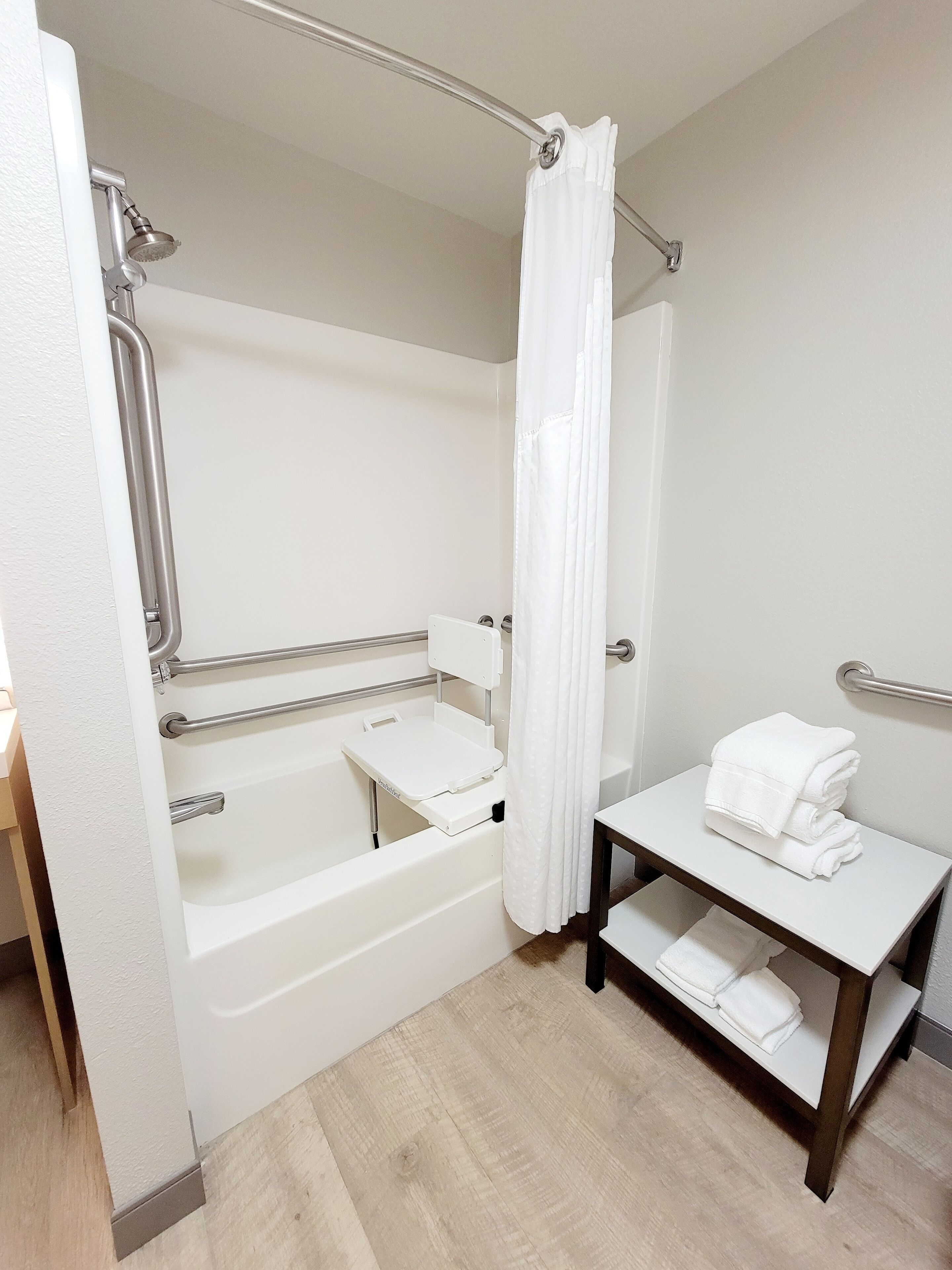 A bathroom with a bathtub, a shower, a toilet, and a sink.