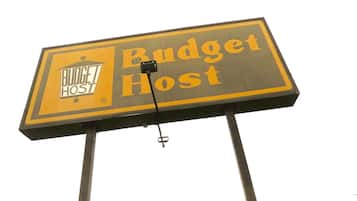 Accommodations at Budget Host feature a house-style roof.