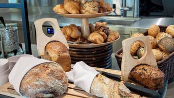 A bakery display with various breads and pastries.
