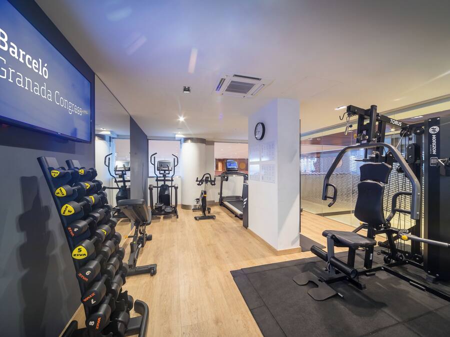A gym with weightlifting equipment, treadmills, and exercise machines.