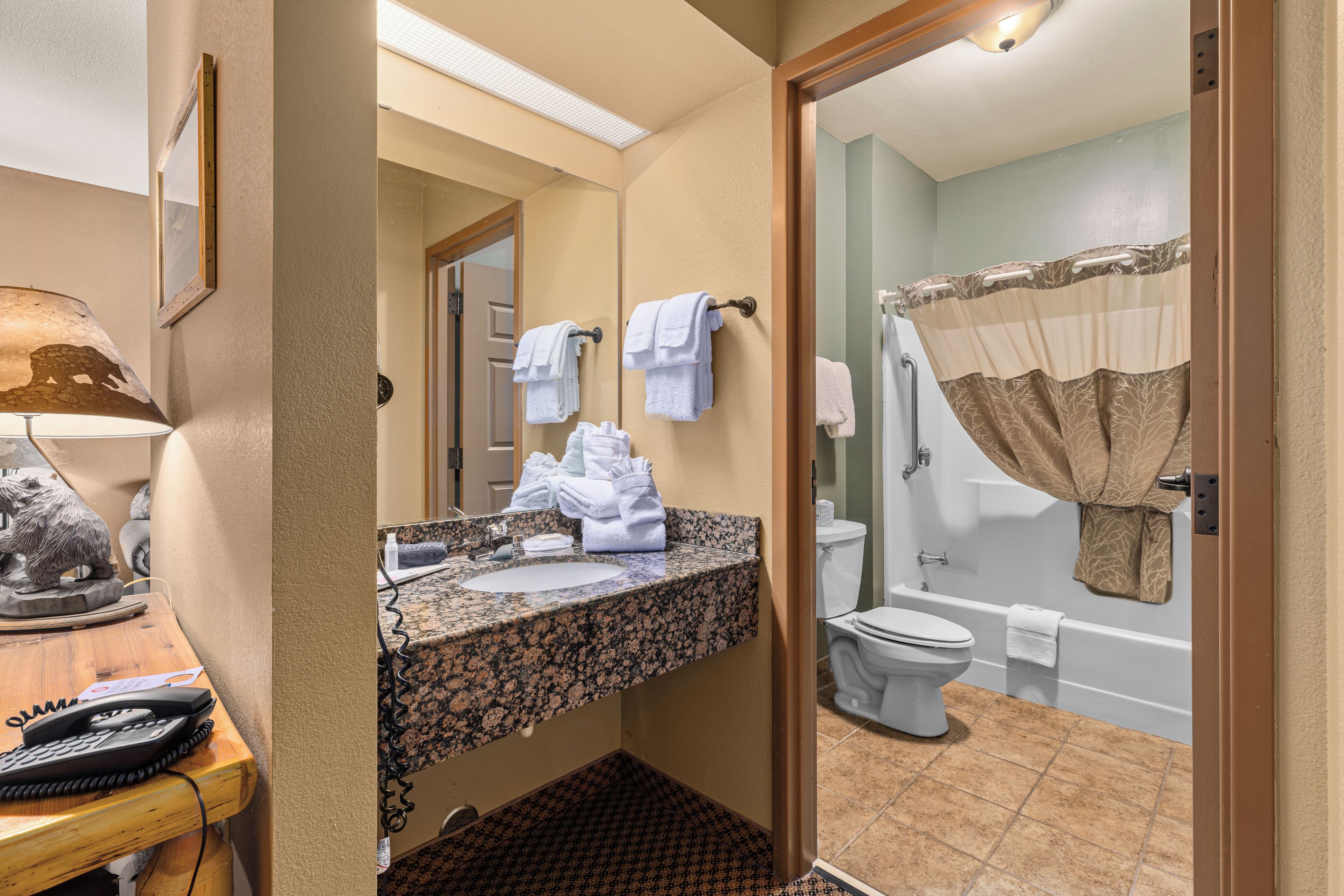 A bathroom with a sink, toilet, and bathtub.