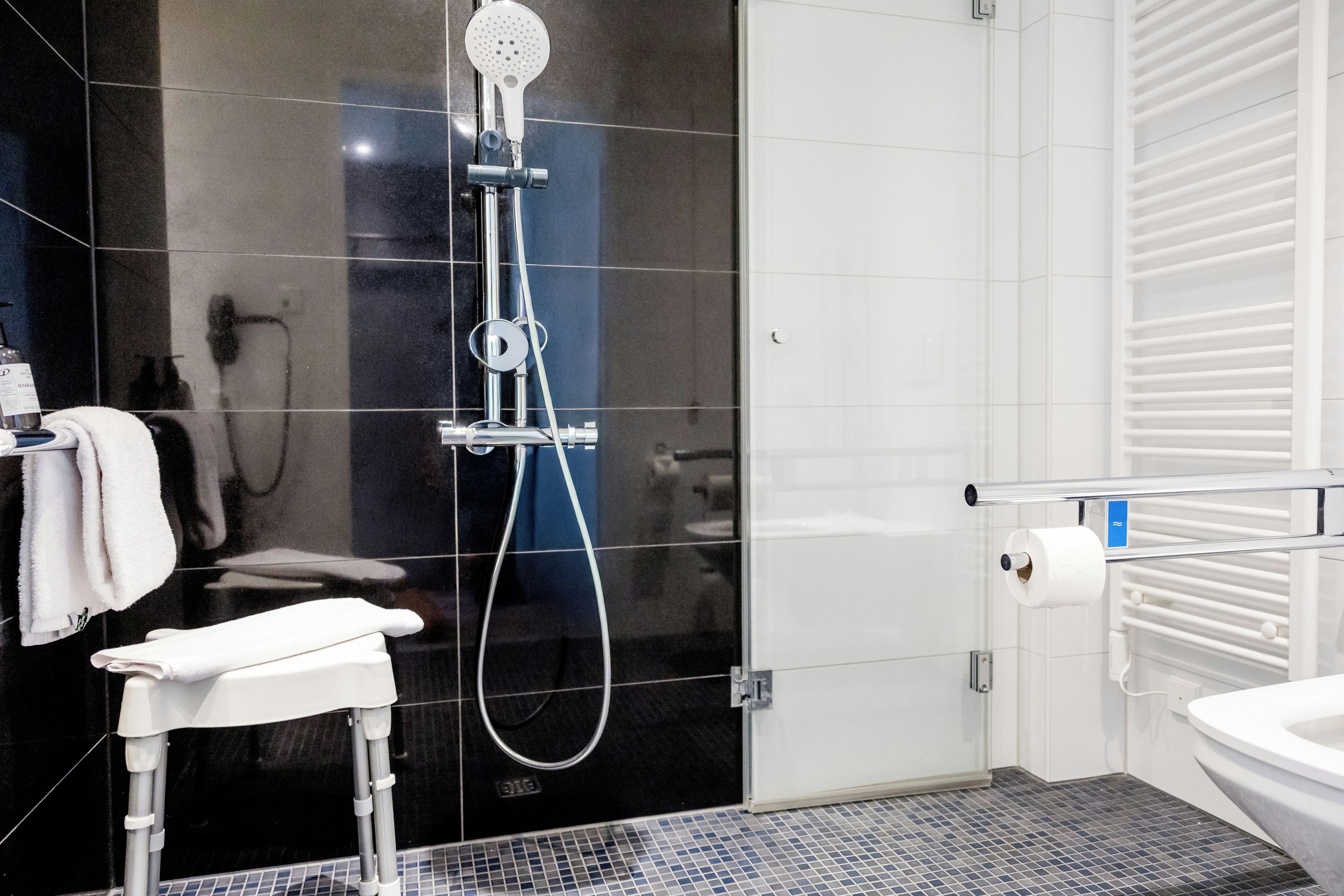 Un baño moderno con ducha, inodoro y lavamanos.