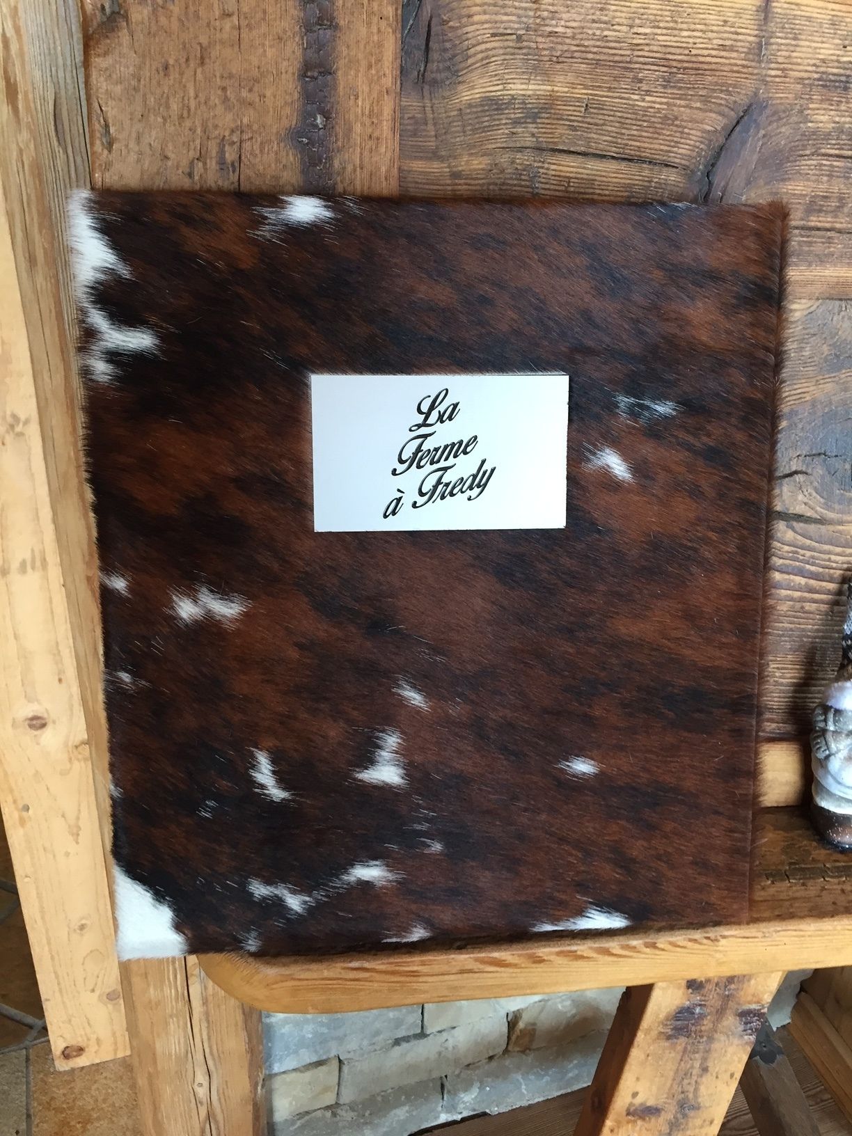 A wooden table with a label that reads "La Ferme à Fredi".