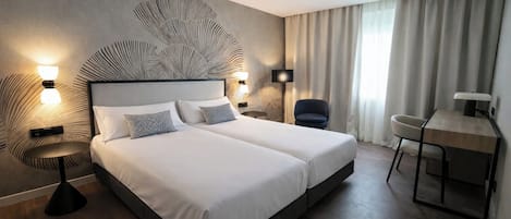 Twin Room | Minibar, in-room safe, desk, blackout curtains