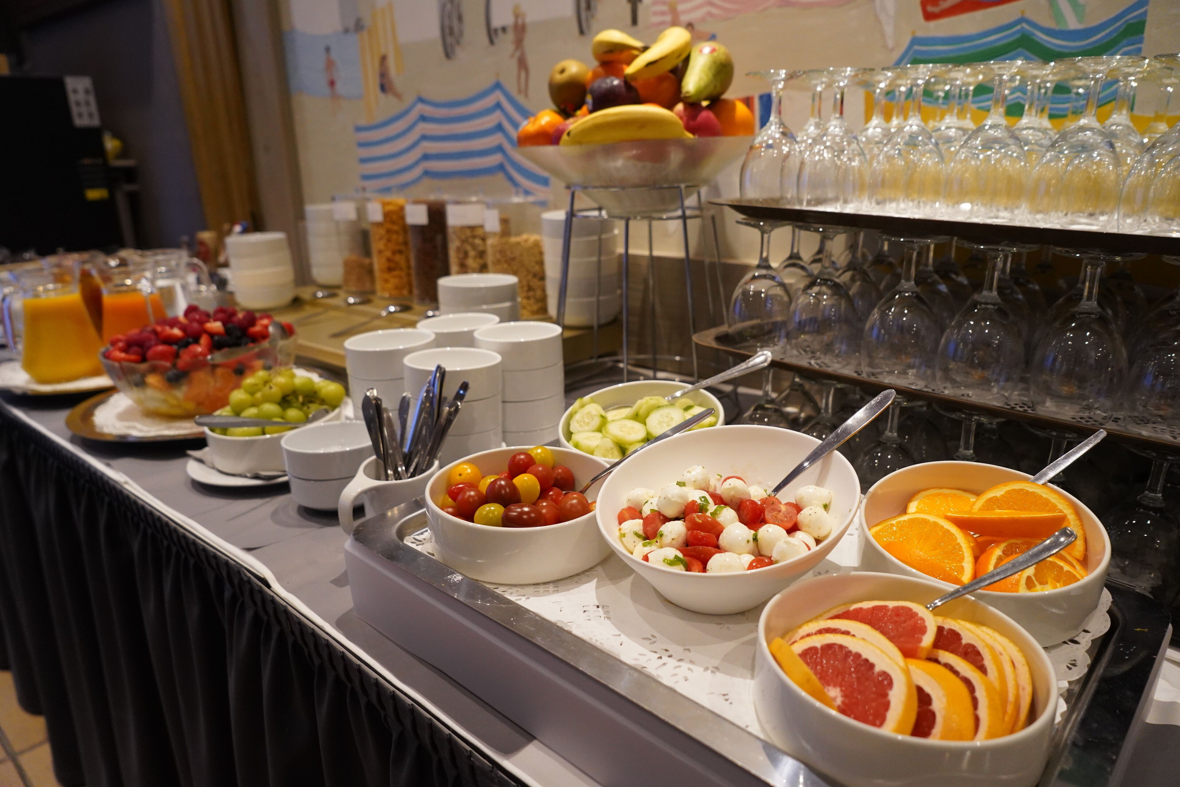 A buffet with various food items and beverages.