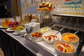 A buffet with various food items and beverages.