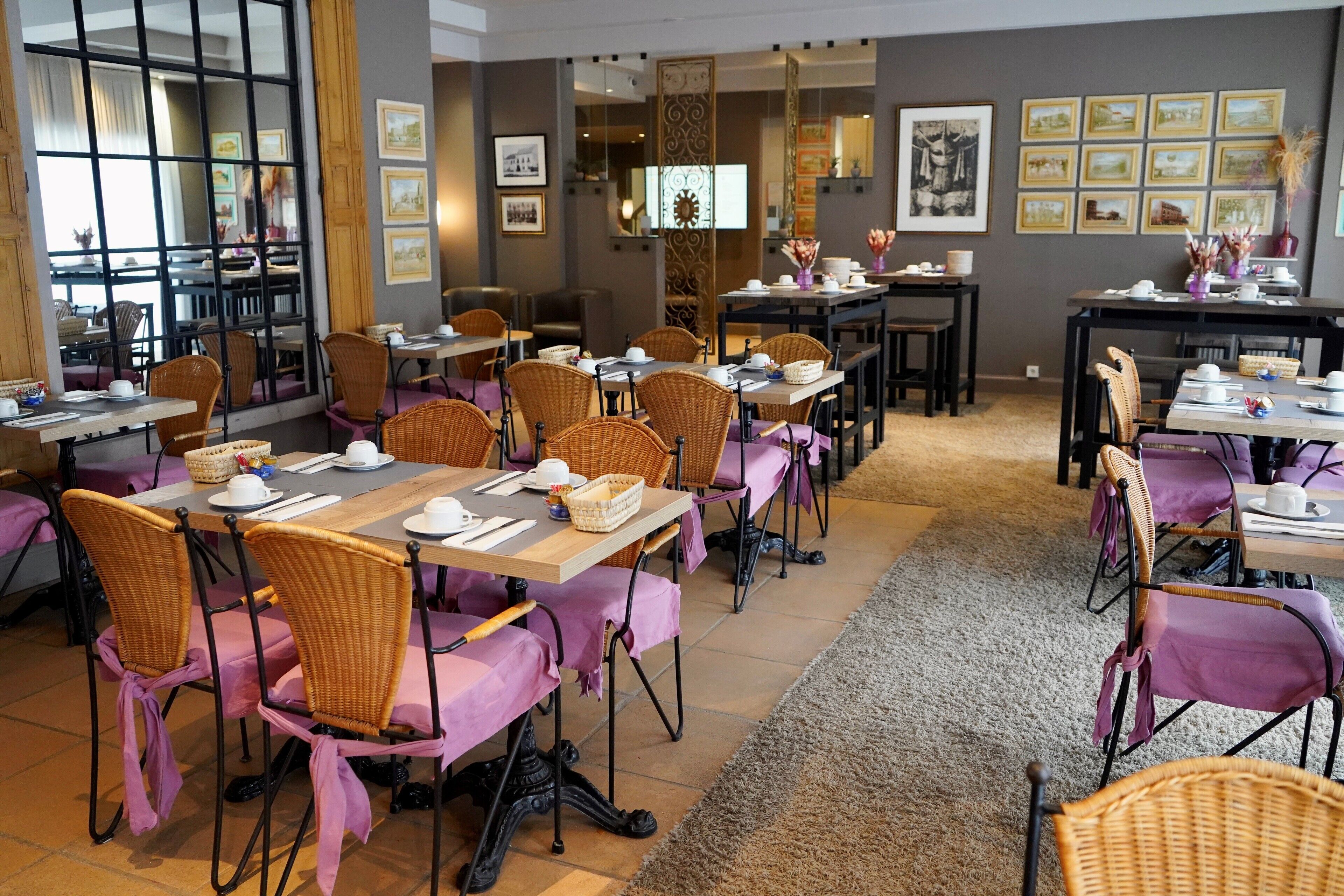A dining area with multiple tables and chairs, each set with white plates, cups, and cutlery.