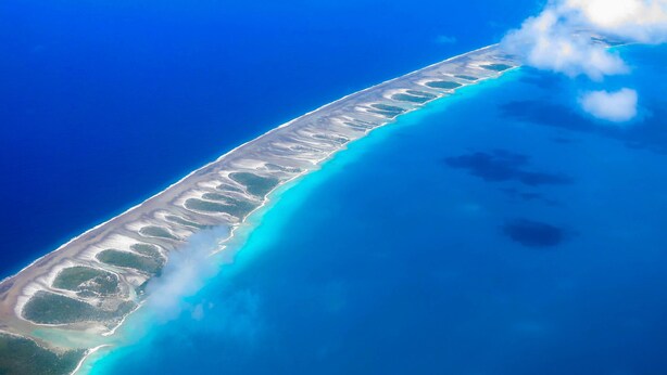 An aerial view of a coastal area with clear blue waters and a sandy beach. - Hotel Kia Ora Resort & Spa (Rangiroa)
