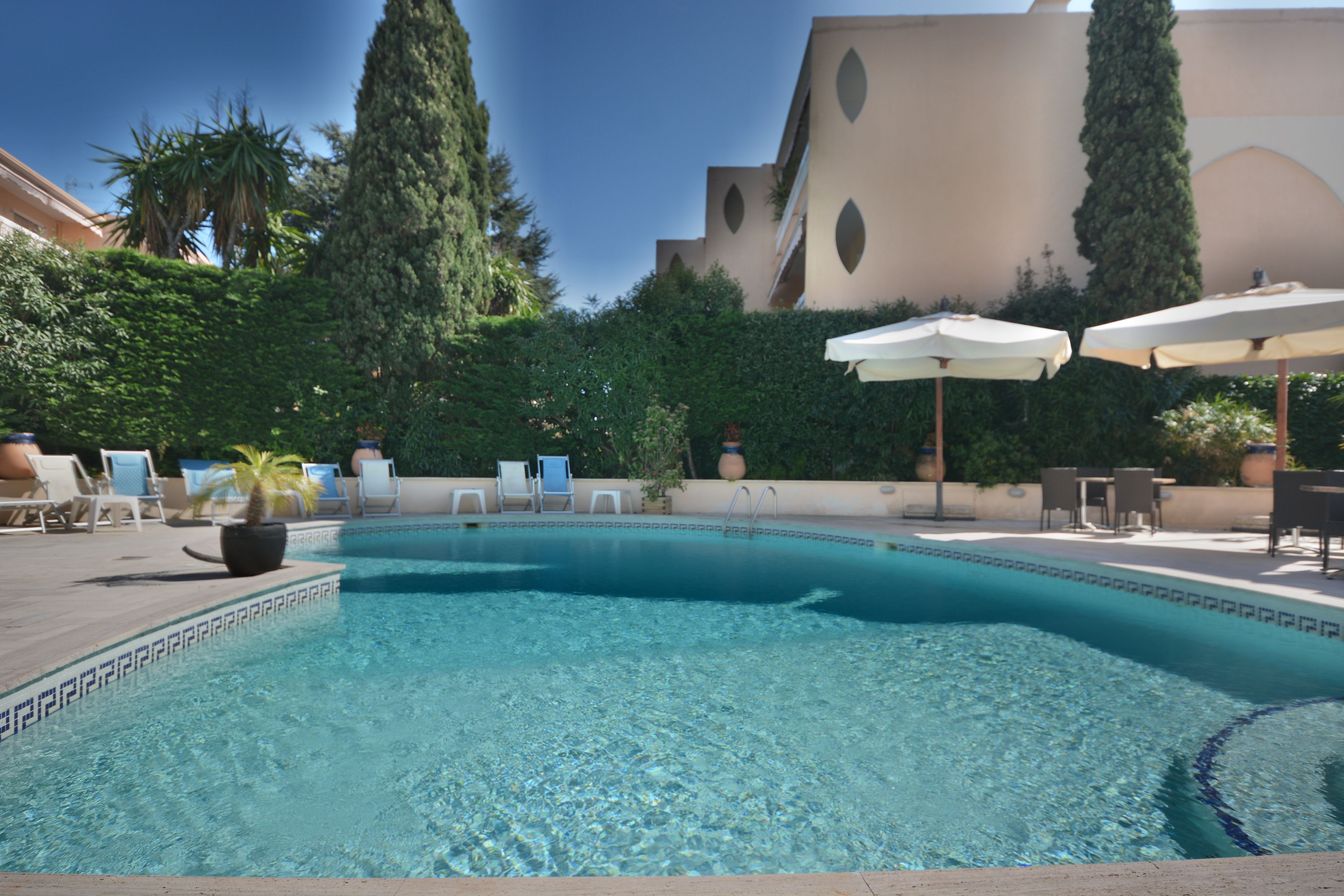 Outdoor pool, open 9:00 AM to 8:00 PM, pool umbrellas, pool loungers