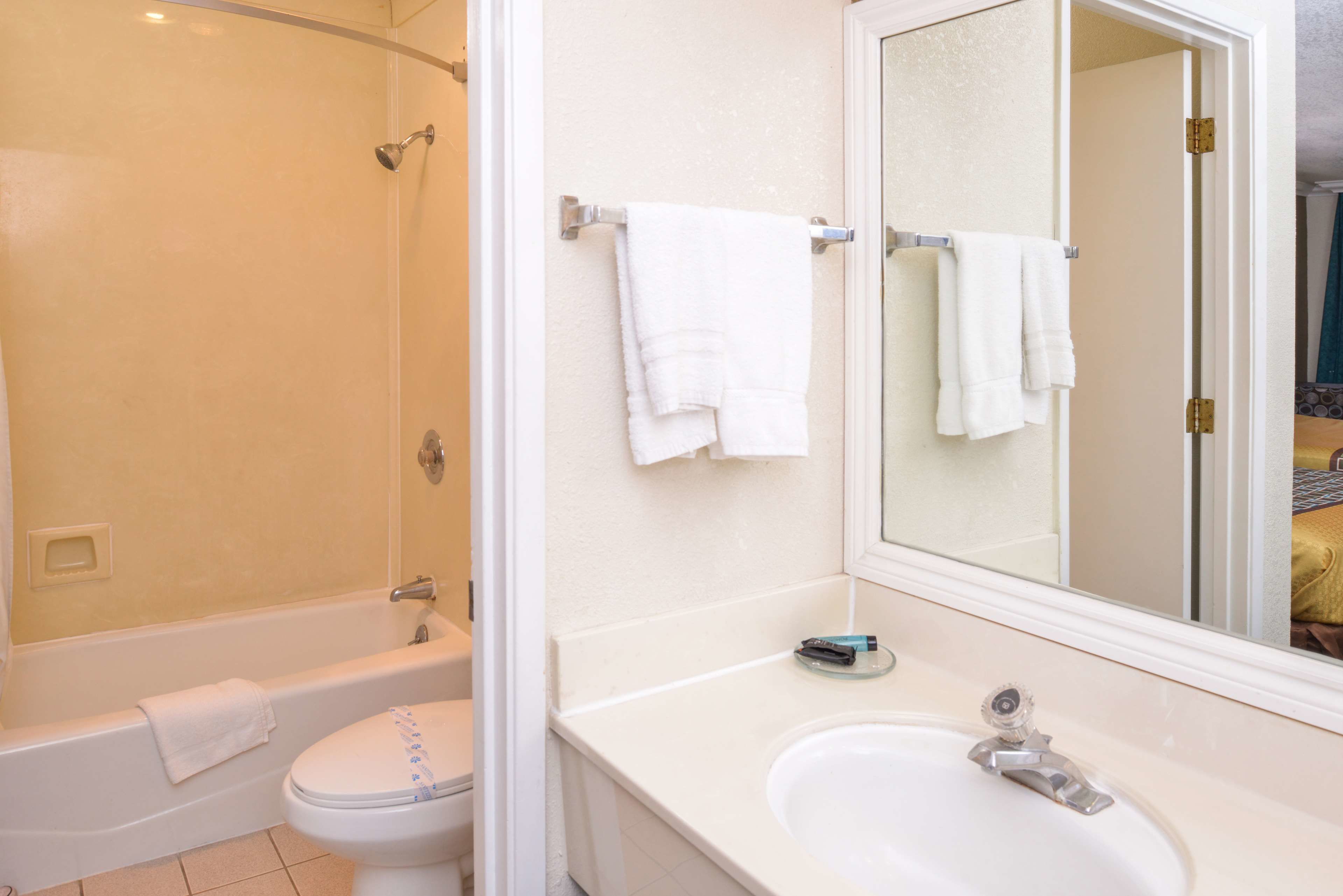 A bathroom with a bathtub, toilet, and sink.
