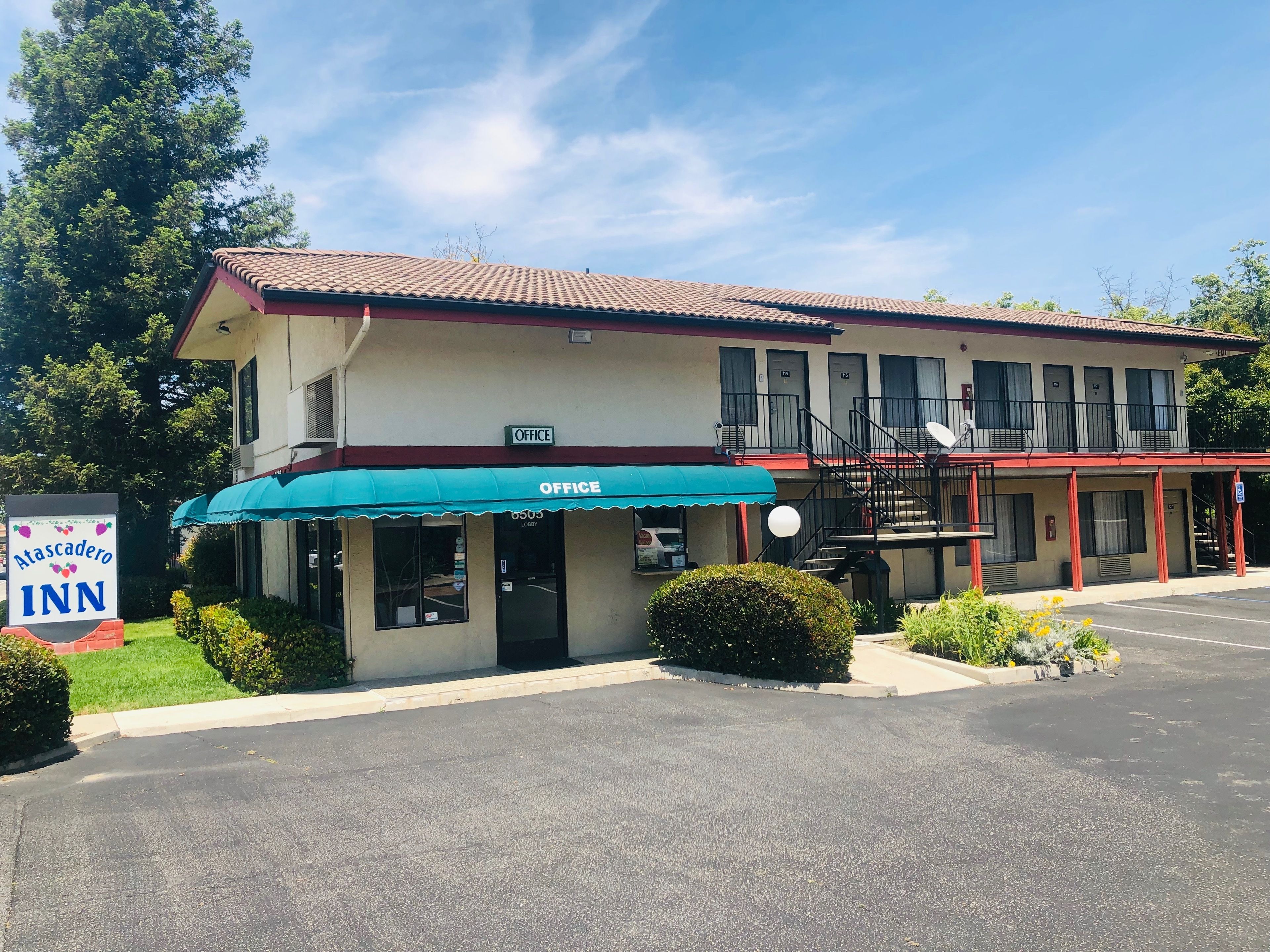 A motel with a sign for 'Atascadero Inn' and an 'Office' sign above the entrance.