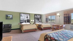 A hotel room with two beds, a sofa, a TV, and a dining area. - Super 8 by Wyndham Winner SD (Winner)