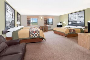 A hotel room with two beds, a desk, a chair, and a couch. - Super 8 by Wyndham Winner SD (Winner)