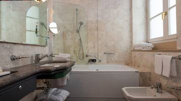 A modern bathroom with a bathtub, a sink, and a mirror.