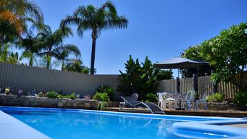 Outdoor pool, open 7:30 AM to 7:30 PM, pool umbrellas, pool loungers