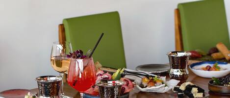 A dining table set with various dishes, drinks, and utensils.