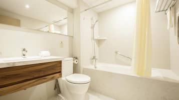 A modern bathroom with a toilet, sink, and shower area.