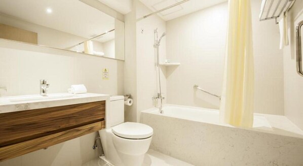 A modern bathroom with a toilet, sink, and shower area. - Inn Hotel Macau (Taipa)