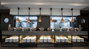 A buffet area with multiple food stations and a variety of dishes displayed.