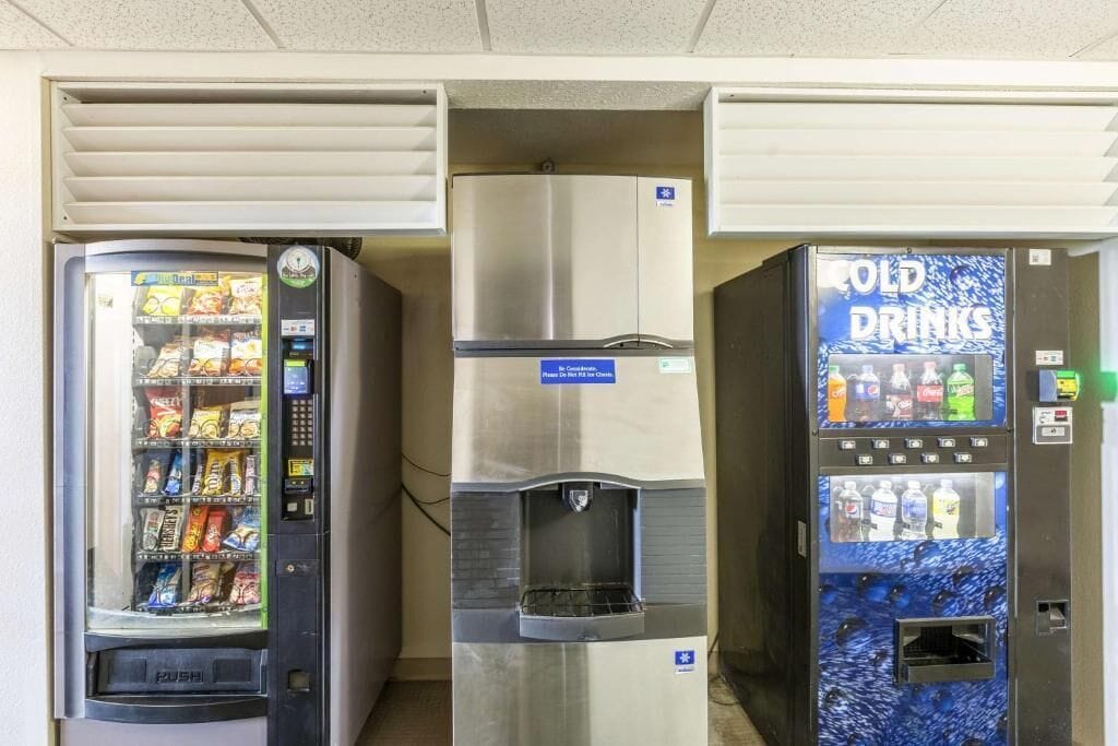 Three vending machines: one with snacks, one with water, and one with cold drinks.