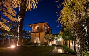 A two-story building with a balcony, surrounded by trees and a small pond. - Club Tapiz (Maipu)
