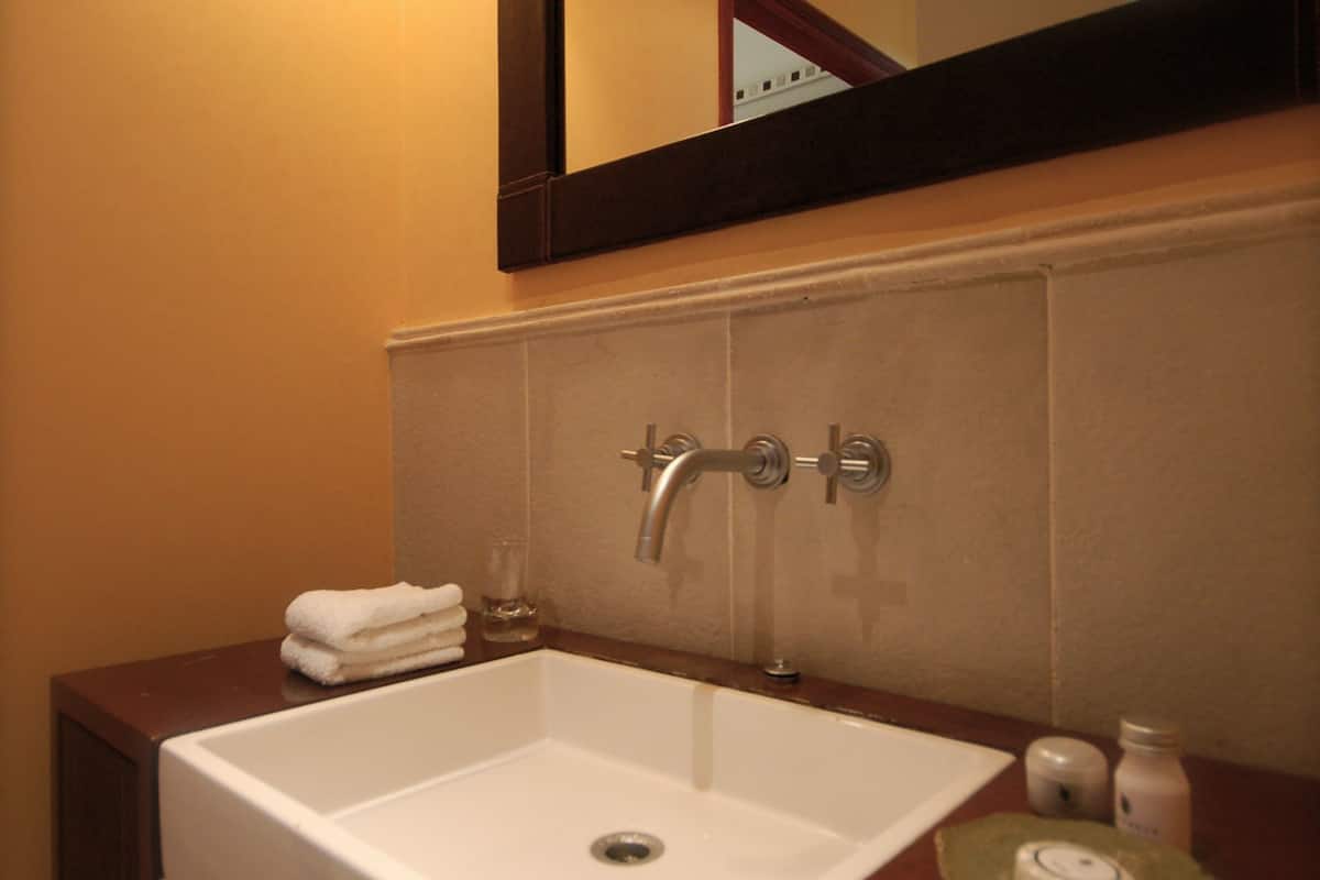 gallery room (vista galeria) | bathroom | combined shower/bathtub, rainfall showerhead, hair dryer, bathrobes