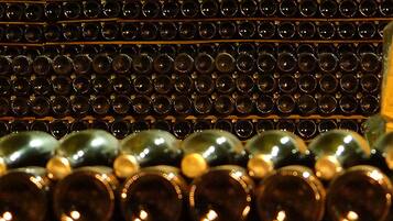A wall of wine bottles arranged in rows.
