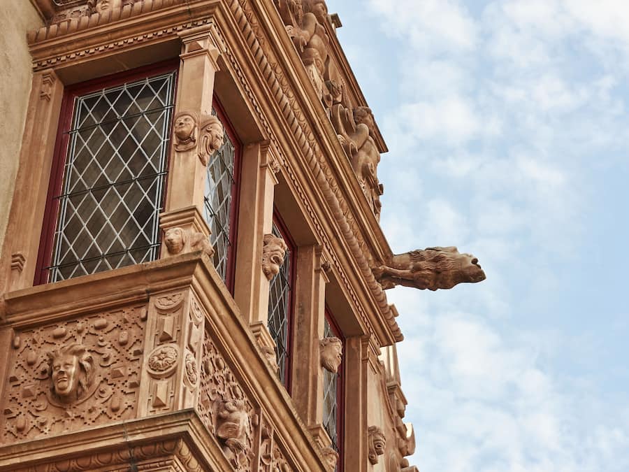 A building facade with ornate architectural details, including sculpted figures and decorative moldings.