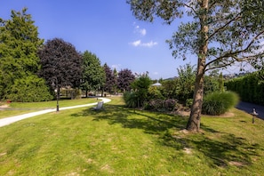 Stroll through the beautifully manicured grounds, featuring a winding walkway and serene gazebo.