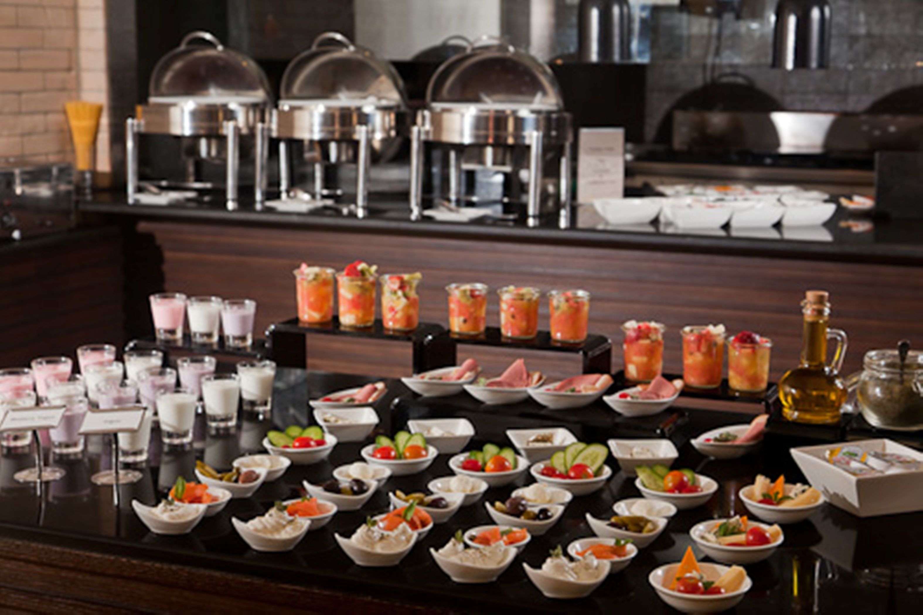 A buffet setup with various food items and beverages.