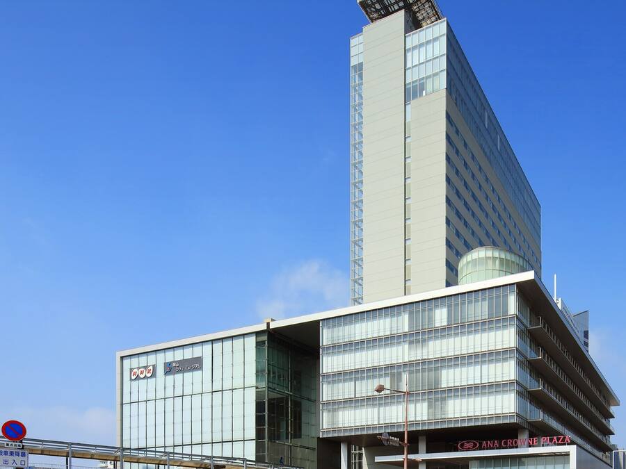 A modern building with a prominent glass facade and a unique angular design.