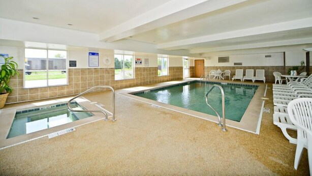 An indoor swimming pool with a separate hot tub, lounge chairs, and a potted plant. - Best Western Penn-Ohio Inn & Suites (Hubbard)