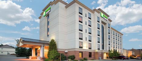 A Holiday Inn Express hotel with a modern design, multiple floors, and a parking lot.