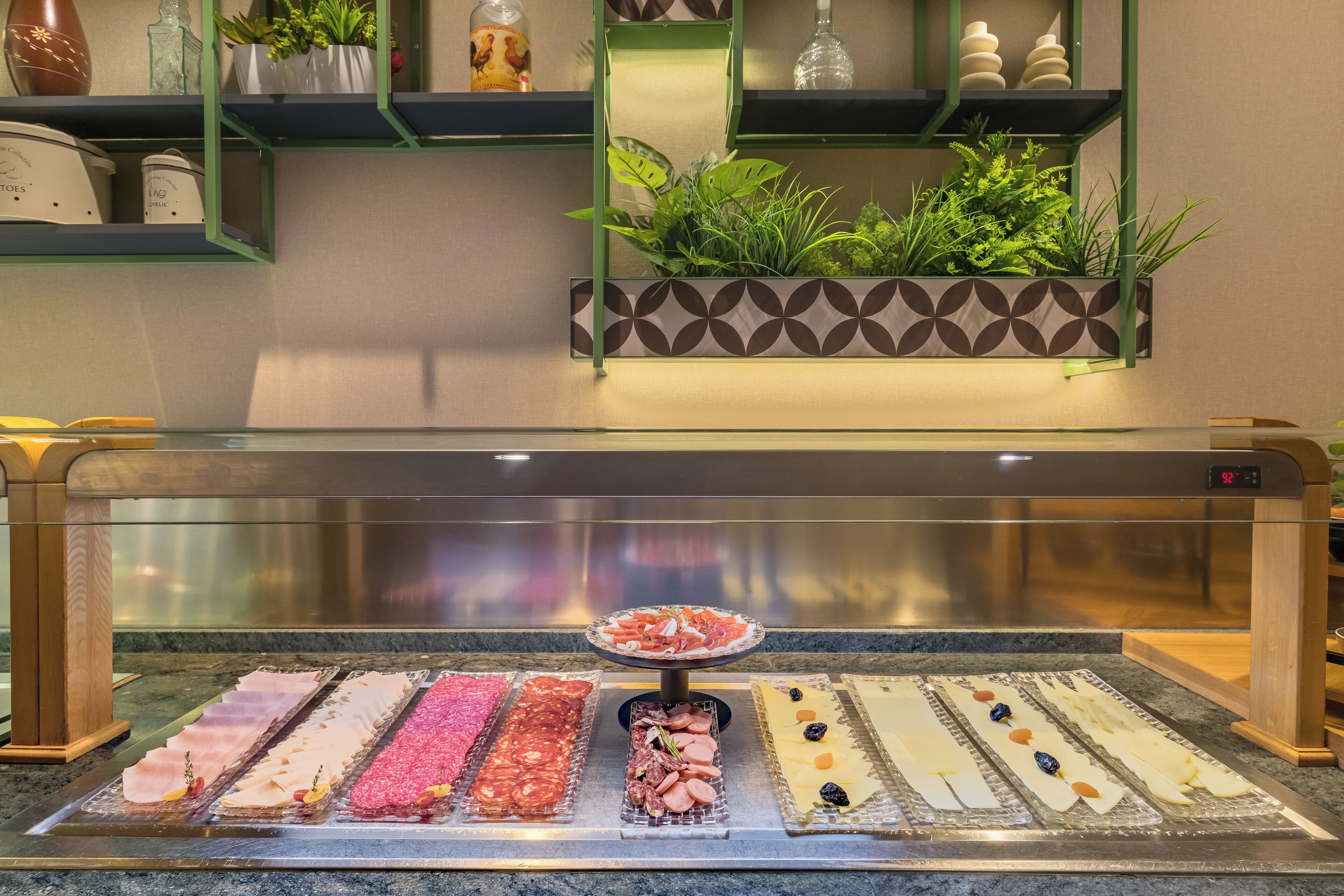 A sushi bar with various types of fresh fish and seafood displayed on a glass counter.