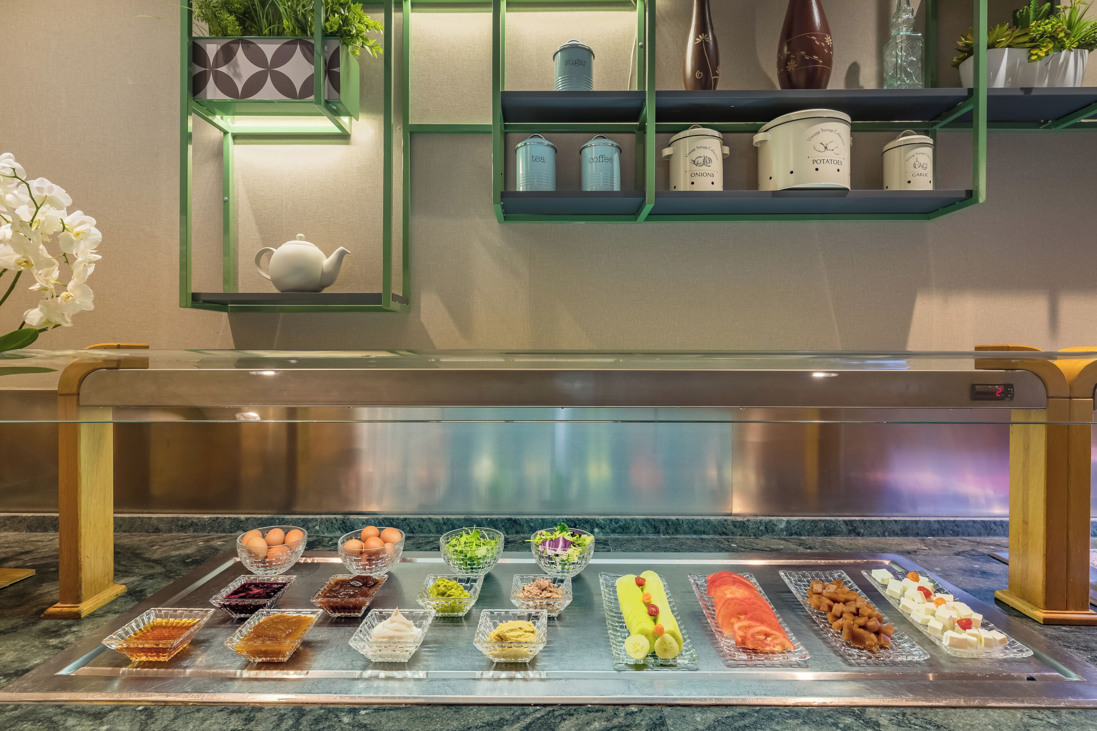 A food display with various dishes and a tea set.
