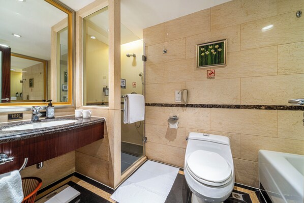 Un baño moderno con un espejo grande, un lavabo, un inodoro y una ducha.