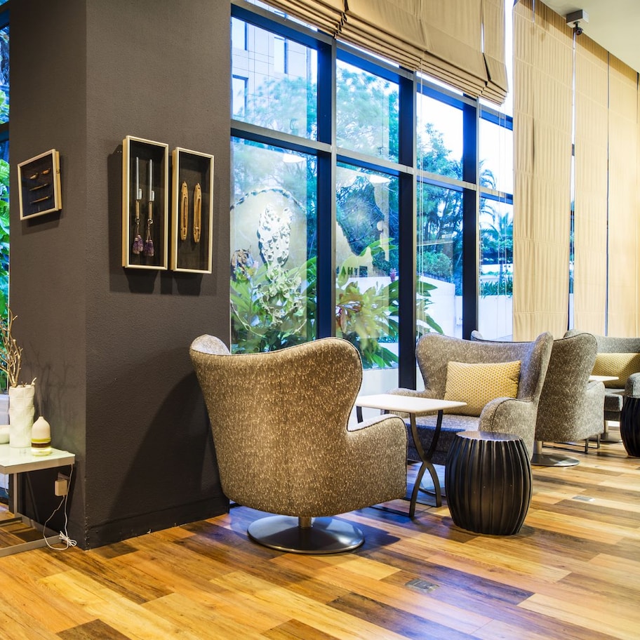 A modern interior with large windows, wooden flooring, and contemporary furniture.