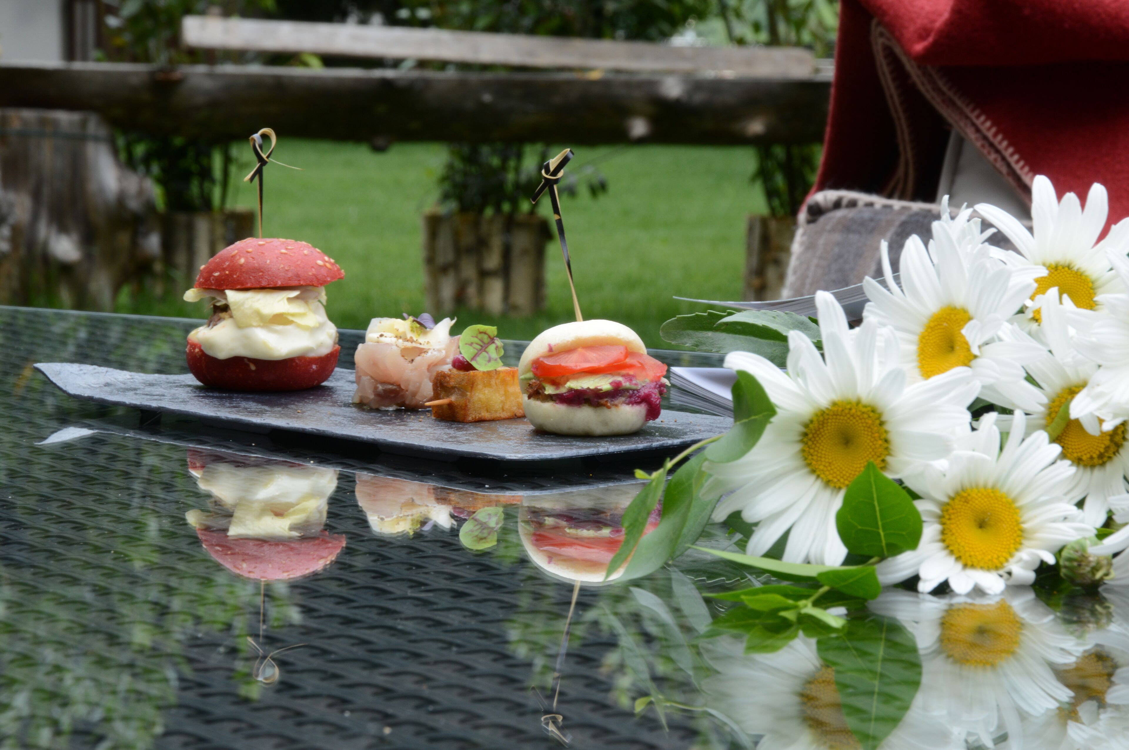 A table with food items and flowers.