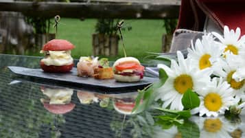 A table with food items and flowers.