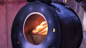 A cylindrical metal structure with a visible opening, possibly a part of a larger machine or equipment.
