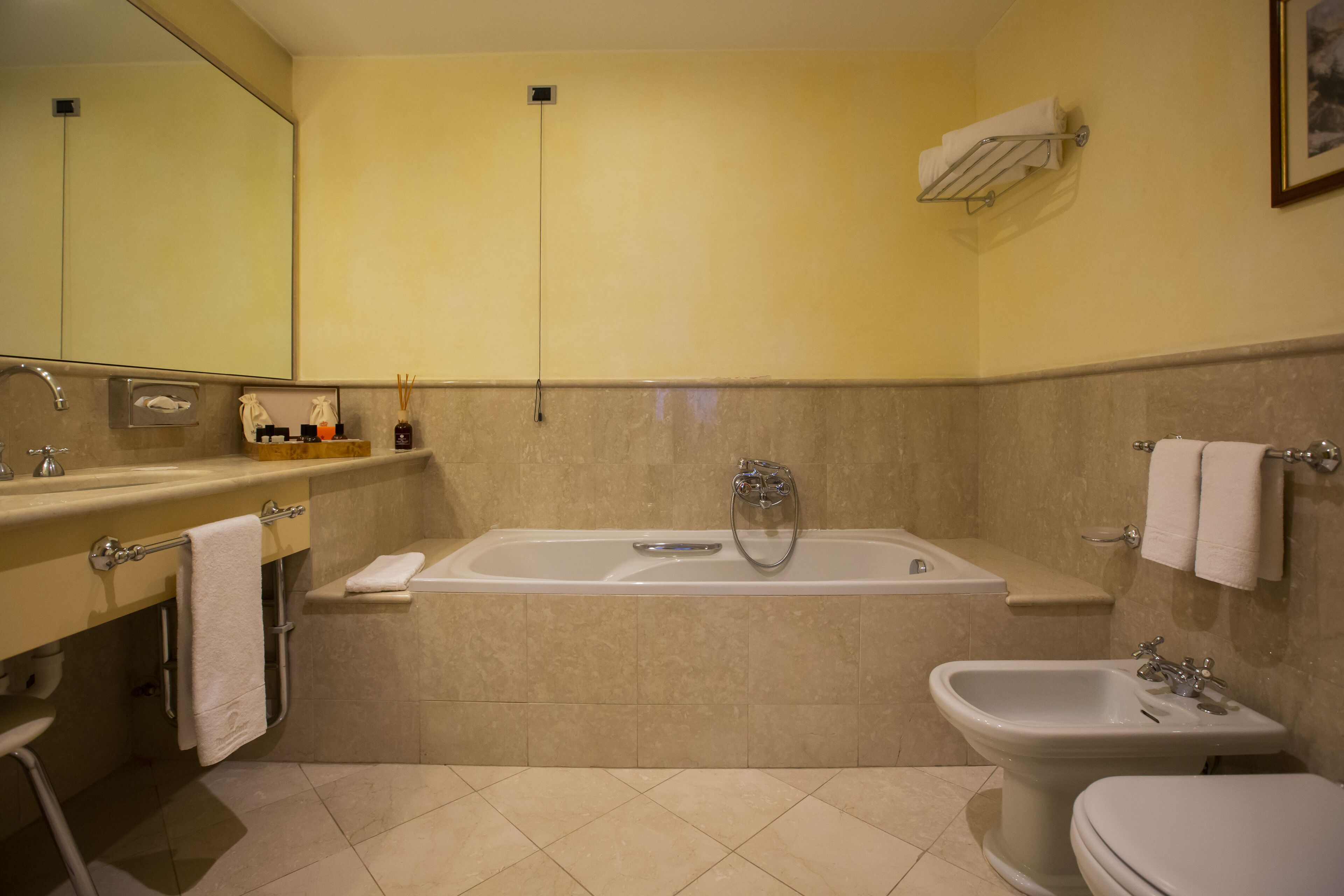 A modern bathroom with a bathtub, sink, and toilet.