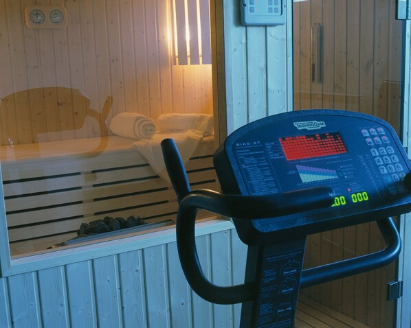 Una sauna con panel de control y banco de madera.